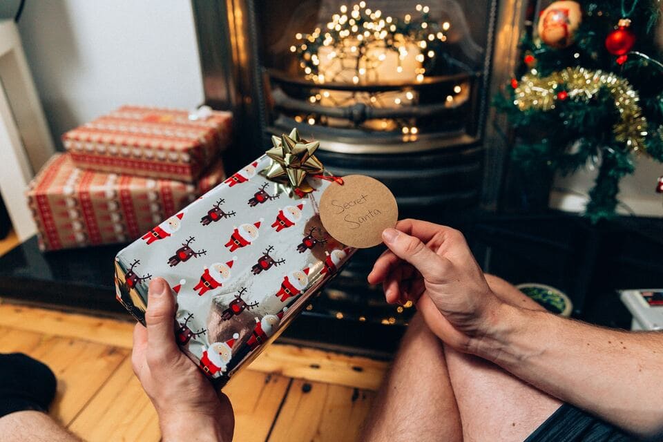 A person holding a christmas gift